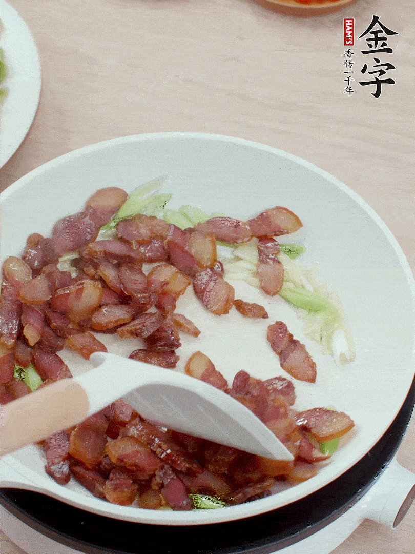 鍋中少許油，姜、蒜白爆香，下臘肉煸出油脂。